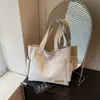Bolsa de Lona Estética de Alto Valor para Mulheres, Grande Capacidade, Bolsa de Ombro para Estudantes, Bolsa de Mão Portátil, Novo Estilo Tendência Primavera/Verão 2026
