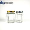 Venta al por mayor de fábrica botella hexagonal transparente de vidrio para miel multi-especificación botella vacía de miel y mermelada frasco hexagonal para alimentos Botella para pepinillos