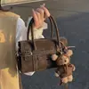 Nova coleção de primavera de 2026: uma bolsa de ombro elegante e versátil para noivas, uma bolsa transversal simples e prática para o dia a dia, e uma bolsa de mão fashion para mulheres