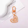 Hebilla de puerta de aleación colorida llavero de acrílico con corazón de purpurina colgante DIY versátil para bolsa funda de teléfono campana