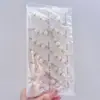 Nuevo pin de cintura de perla sintética, artefacto de cintura, broche de hebilla anti-luz para cárdigan de punto de mujer, suministro de tienda de 2 yuanes