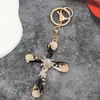 Llavero Cruz de Piedra Ojo de Gato de Moda Colgante Creativo para Mochila Exquisito Pequeño Regalo Llavero para Coche Venta al por Mayor