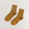 Meias novas femininas cor sólida algodão penteado japonês quatro estações meias cano alto preto e branco JK cor doce meias femininas simples atacado