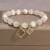 2025 Novo Bracelete Olho de Gato Bracelete de Cristal Trevo de Quatro Folhas Corda Elástica Pérola Shijia Bracelete de Contas de Transferência Atacado
