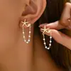 Pendientes para mujer dulces y frescos de estilo coreano con un diseño único de estrella y concha, con detalles de perlas, creando un look sofisticado y versátil