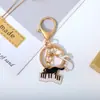 Llavero Colgante Artístico Retro Blanco y Negro Gato Piano Nota Accesorios para Bolso de Niña Colgante Regalo de Concierto