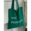 Bolsa de Lona com Estampa de Letras Nova Primavera Grande Capacidade Bolsa de Ombro Feminina Simples Fresca Versátil