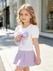 Camiseta blanca de manga corta abullonada para niña, nuevo estilo de verano, con un lazo morado tridimensional en el pecho, top dulce y elegante