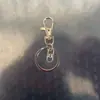 Clipe de Cachorro Giratório Conjunto de Corrente de Quatro Seções Conjunto de Três Peças, Clipe de Cachorro com Fivela em Oito, Mosquetão, Pingente de Contas, Chaveiro com Mosquetão