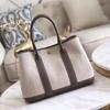 Lona de Novo Estilo Transfronteiriço com Bolsa Feminina de Couro de Primeira Camada, Bolsa de Mão de Jardim, Bolsa Tote Transversal de Ombro Único com Bloqueio de Cores em Couro Genuíno