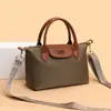 Bolsa tipo dumpling de color block de comercio exterior para mujer, nuevo modelo 2026, bolso de hombro casual versátil, bolso de mano texturizado para ir al trabajo y uso cruzado