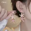 Pendientes de resina con forma de estrella de mar y concha de aguja plateada, pendientes exquisitos estilo resort costero, pendientes de diseño nicho para mujer con un toque de alta gama