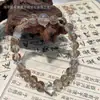 Qiaoen pulsera de oro negro natural súper multi tesoro luz de luna negra cristal blanco diseño Joker pulsera al por mayor