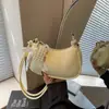 Bolso de axila de nicho coreano para mujer 2026 Nuevo de moda con encaje en forma de media luna Bolso de hombro simple