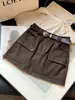 Falda de mujer dulce y fresca estilo workwear, nuevo diseño de otoño con bolsillos, de cintura alta, línea A, anti-exposición, falda corta ajustada