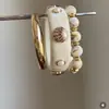 Pulsera redonda de cuentas con carcasa de resina degradada, sensación de lujo ligero de alta gama, accesorio de mano con diseño personalizado al por mayor