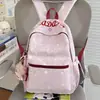 Nuevo modelo 2026 mochila casual estampada estilo ins para estudiantes de secundaria y primaria, mochila ligera de gran capacidad para ir a la escuela para niñas