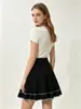 Venta al por mayor transfronteriza desde la fábrica de origen: falda corta de punto para mujer de cintura alta, línea A, con pliegues y bordado color block, estilo europeo y americano