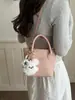 Bolso de mano de color liso con diseño único, bolso tipo cubo de moda, versión coreana ins dulce moderno para hombro y cruzado para mujer