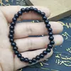 Pulsera de obsidiana cuentas de vidrio negro anillo único pulsera de cuentas de Buda decoración de mano para hombres y mujeres suministro de puesto de lugar escénico venta al por mayor