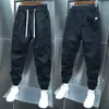 Pantalones casuales de primavera y verano 2023 para hombre, overol de fila de botones atado al tobillo, marca de moda, costuras, pantalones harén tipo lápiz para hombre