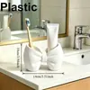 Soporte para cepillos de dientes con forma de lazo Sin instalación Plástico Soporte de almacenamiento Baño Dormitorio Tipo bolígrafo Soporte de exhibición para cepillos de dientes