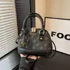 Bolso de mano de moda transfronterizo para mujer 2026 nuevo modelo bolso cruzado de lujo ligero bolso cruzado clásico con estampado bolso cruzado de hombro tipo concha