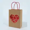 En stock Día de San Valentín Rojo amor amarillo piel de vaca regalo bolsa de papel portátil Papel Kraft dorado bolsa de papel de embalaje de alta gama