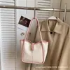 Bolsas de mano para mujer transfronterizas, nuevo modelo 2026, bolso de hombro y bandolera de alta gama a la moda para mujer, bolso de mano simple para el día a día, bolso tipo cubo