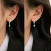 Pendientes de estrella asimétrica de cuatro puntas, pendientes de lujo ligero de alta gama, joyería de venta caliente 2026, pendientes de aro con estrella y cruz de cuerda de cáñamo