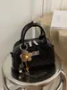 Bolso tipo Boston transfronterizo de nicho para mujer, nuevo bolso de hombro de moda 2026 con patrón de diamantes, bolso bandolera de cadena exquisito