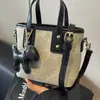 Bolsos de nicho texturizados de alta calidad 2024 nuevos bolsos para mujer versátiles bandoleras retro de hombro bolsos cubo portátiles de moda