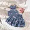 2026 Chaleco de Mezclilla con Cuello Halter y Solapa + Minifalda de Mezclilla con Lazo Conjunto de Moda Europea y Americana para Niñas Transfronterizo