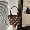 Diseño de bolso retro sentido de nicho bolso de mano mujer 2026 nuevo lunares gamuza felpa bolso cubo bandolera