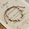 Jingdezhen Navidad Pulsera de Cuerda Trenzada de Cerámica Pulsera de Trébol de Cuatro Hojas Joyería Artística Hecha a Mano Venta al por Mayor Pulseras de Cerámica para Atracciones Turísticas