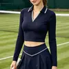 Camisa polo casual de manga comprida feminina de novo estilo transfronteiriça com cintura alta e design de cores contrastantes, adequada para golfe e tênis, e apresentando uma saia embutida para evitar exposição.