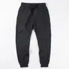 Venta al por mayor transfronterizaPantalones casuales finos de seda helada de verano para hombre Pantalones japoneses simples con tobillo atado elástico Pantalones cargo holgados
