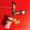 Beige Agua Oro Puro 999 Cilindro de Bendición Instantánea Llavero Colgante para Bolso de Pony Regalo Navideño para Novia Venta al por Mayor