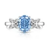 Transmisión en Vivo Más Vendido Anillo Huevo de Paloma Cortado Flor de Hielo de Piedra Preciosa de Color para Mujer Incrustado con Diamante de Alto Carbono Anillo de Mariposa Fabricante Dropshipping