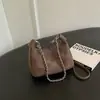 Bolsa feminina 2026 estilo coreano nova, bolsa de mão, bolsa de ombro, bolsa transversal de inverno vintage com pingente de coelho de pelúcia, camurça da moda