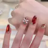 2026 Dança do Leão Cereja Vermelha Gatinho Olho de Gato Outono/Inverno Novo Estilo Elegante Clareador Arte de Unhas Feita à Mão Pontas de Unha Atacado