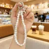 Nuevo Colgante de Cristal Super Brillante Acrílico Bolsa Auriculares Bluetooth Colgante Pequeño Llavero de Coche Cadena para Teléfono Móvil Venta al por Mayor