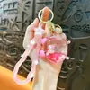 Llavero Creativo de Muñeca Pequeña con Reloj Despertador Líquido Lindo Colgante de Arena Movediza para Bolsos Accesorios Pequeños Regalos al por Mayor