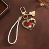 Presente de Dia dos Namorados chaveiro pingente coração de cristal pulseira de celular fofa decoração de bolsa coração acessório criativo