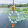 Estilo Étnico Aleación Porcelana Esmaltada Cadena para Teléfono Móvil Llave Thangka Cinco Vías Dios de la Riqueza Colgante Chapado en Oro Joyería de Palacio