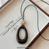 Nuevo colgante estilo chino collar largo irregular nuevo estilo para mujer sensación de alta gama accesorios de cadena para suéter de otoño e invierno diseño de nicho