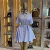 Moda Feminina Transfronteiriça Europeia e Americana Verão 2026 Novo Estilo Elegante Gola Lapela Manga Longa Bolso Cintura de Amarração Vestido Camisa