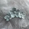 Comercio exterior al por mayor europeo y americano simulación de mármol bauhinia dulce clip para el pelo pintura en aerosol camelia brillante clip de tres flores