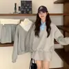 Conjunto versátil de dos piezas para otoño: sudadera de retazos con cuello polo de dos piezas falsas y minifalda de color liso estilo Miu