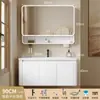 Tocador de baño engrosado y ahorrador de espacio con diseño en color crema, que cuenta con un lavabo redondeado, lavabo cerámico integrado y un lavabo de una sola pieza.